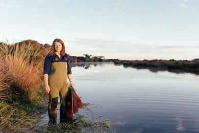 Woman standing in wetlands. 