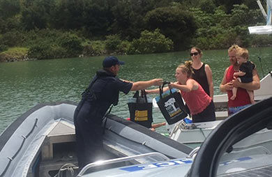 Bay of Islands Police help distribute boaty bags in the Bay of Islands. 