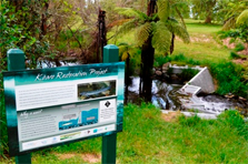 View of information panel with the concrete trout barrier shown in the background