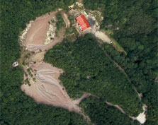 Aerial view showing the poppet head (centre left), mullock heap, and red engine house at top. Photo: K L Jones.