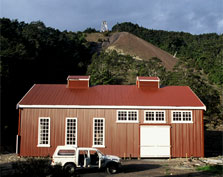 The re-constructed engine house. The poppet head can be seen on top of the mullock-covered hill in the background. Photo: K L Jones.