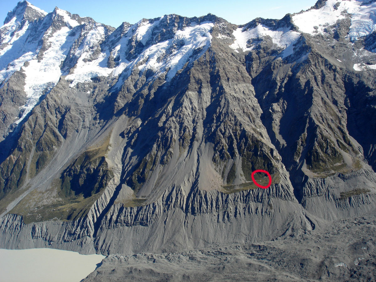 Showing historic Hooker Hut's position above the crumbling moraine wall of the retreating Hooker Glacier. 