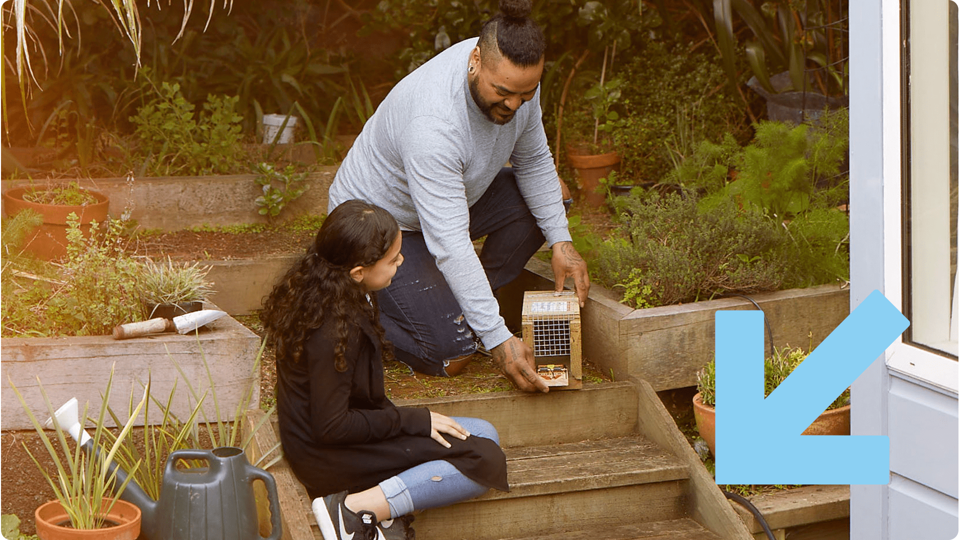 Father and daughter set up a trap in the backyard.