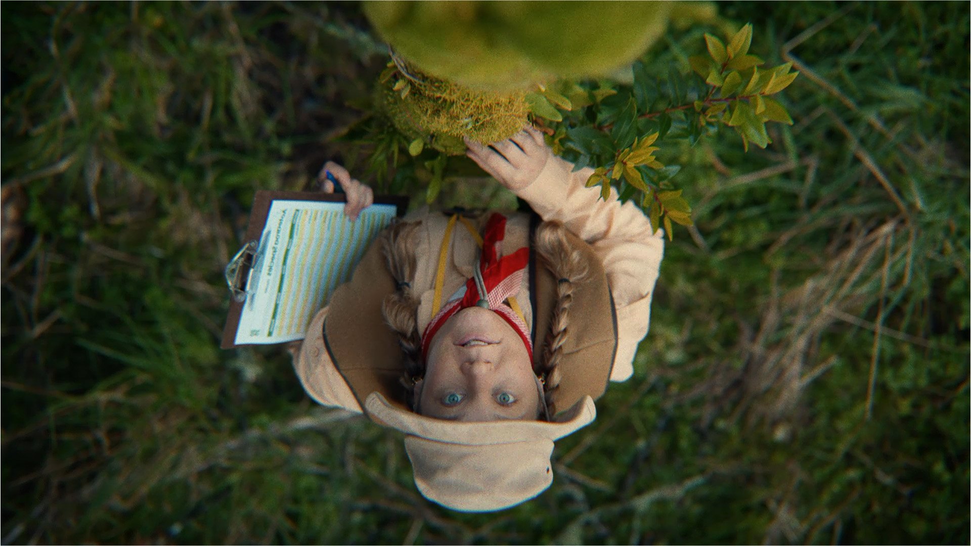 Upside down photo of woman standing near plants.