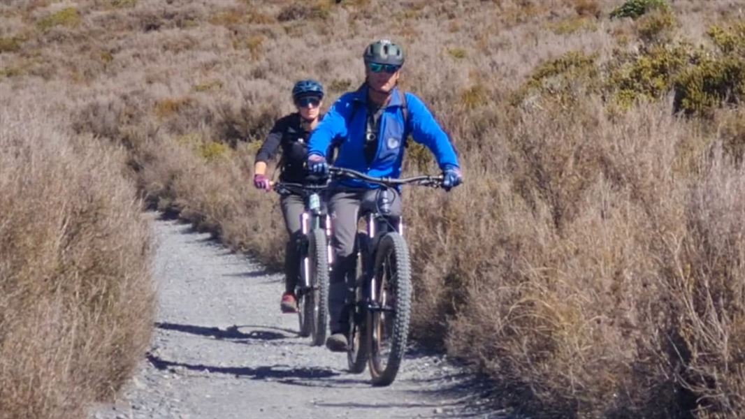 Two mountain bikers on the Tongariro Crossing track.