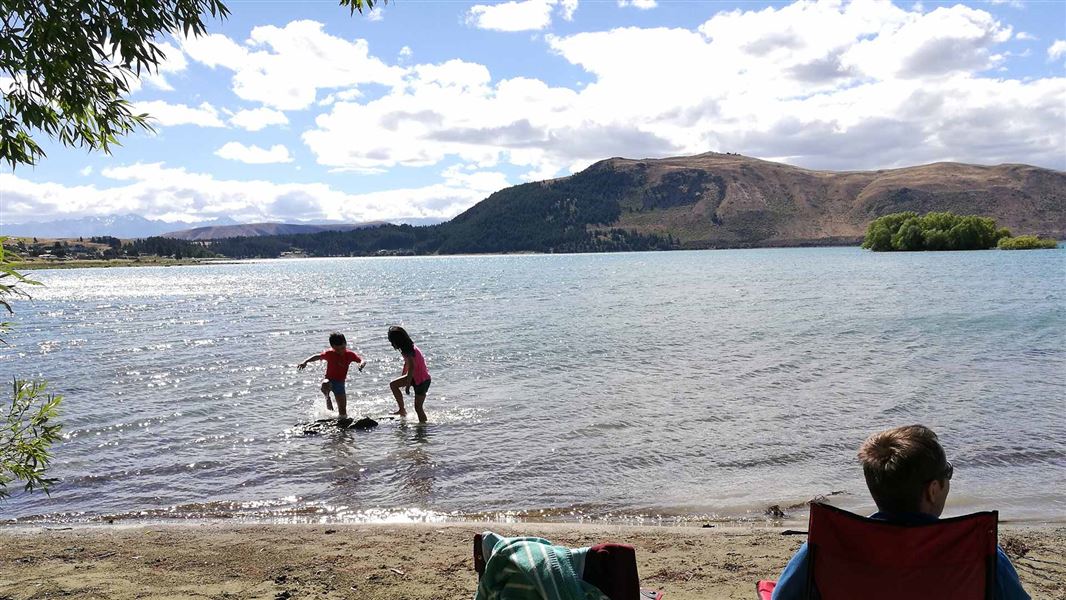 Two children playing in the water.