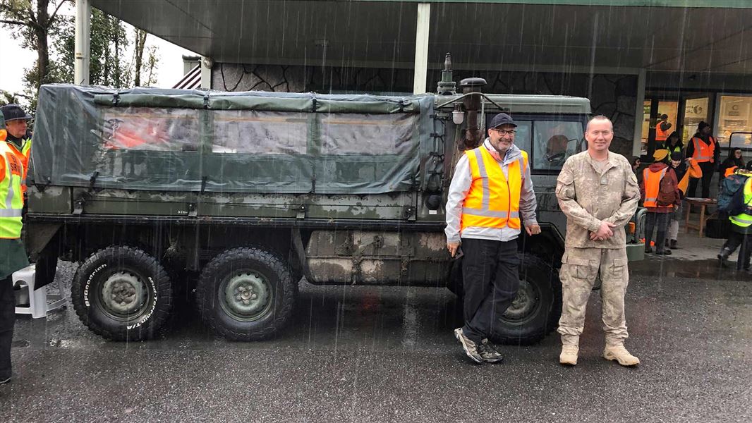 Lou Sanson with Major Steve Jackson, Officer Command, standing in front of a Pinzgauer light operational vehicle. 