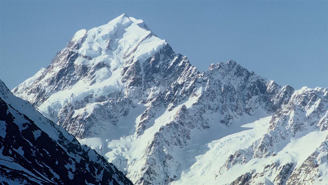 View of craggy, snow covered mountain.