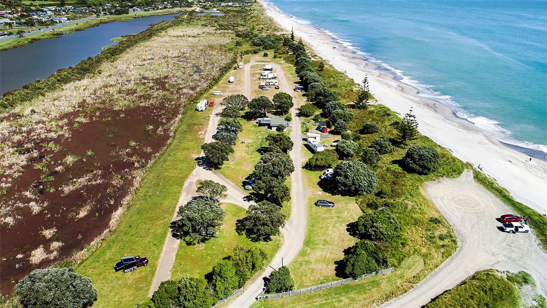 Aerial photo looking down at a campsite alongside the beach