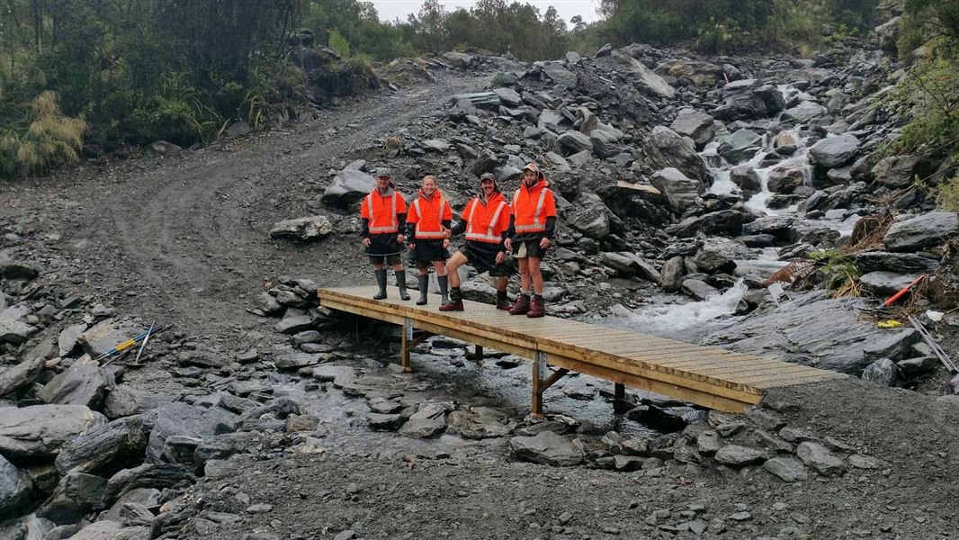 DOC staff on a section of the Fox Glacier track that was washed out in early November. 