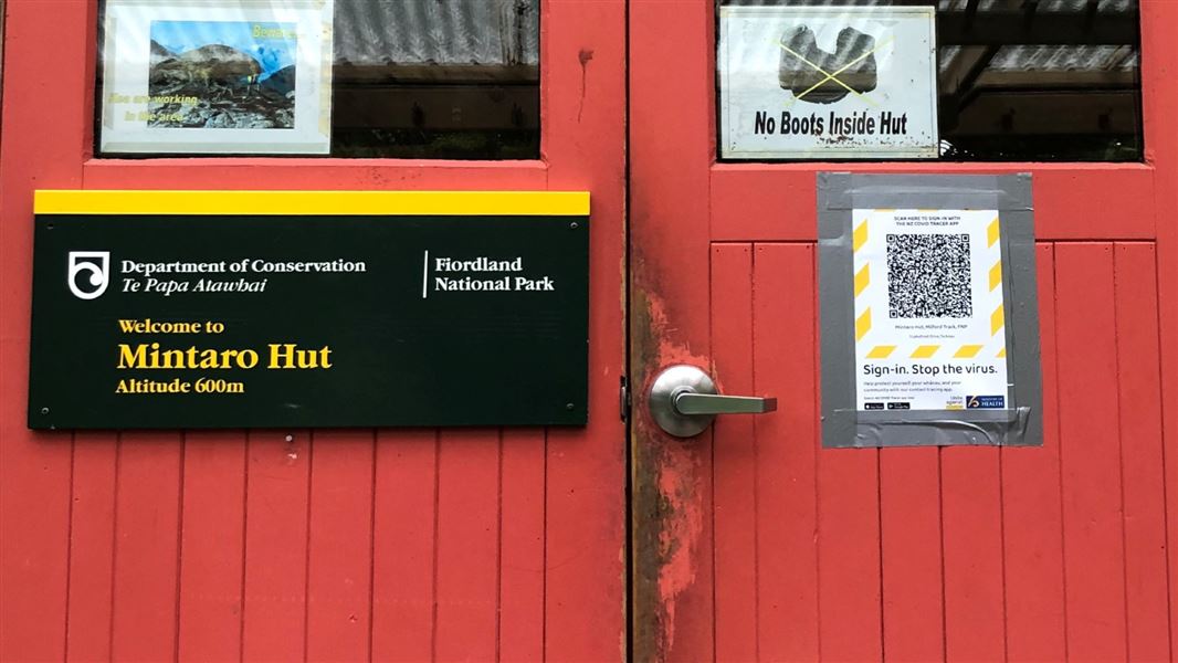 Large red doors with a QR code attached.