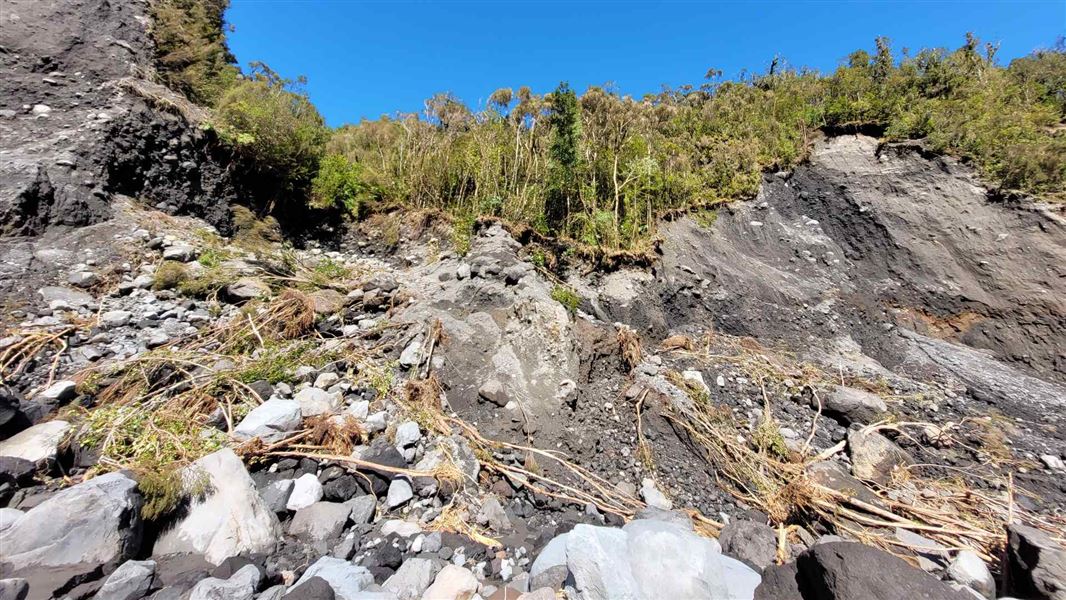 A picture of a rubble at the base of a cliff 