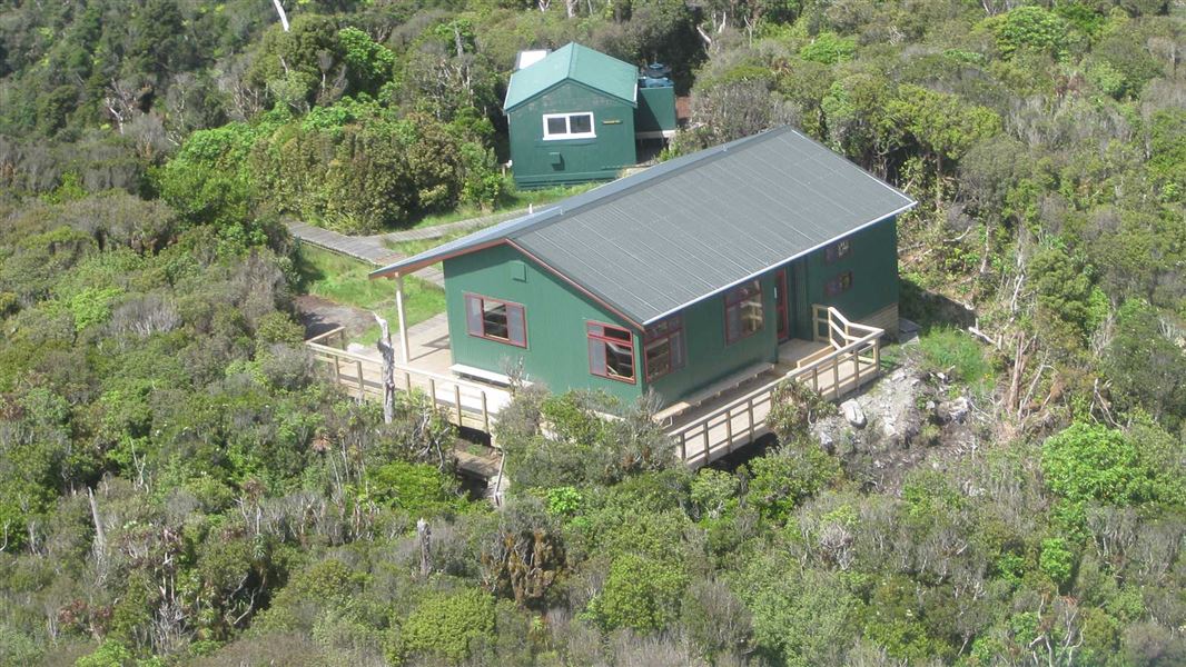 Aerial view of Pāhautea Hut with campers shelter. 