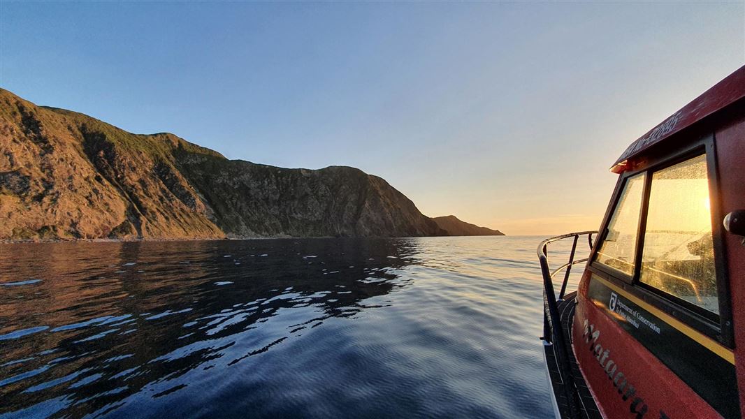 Kapiti Island at sun set from a boat on the water. 