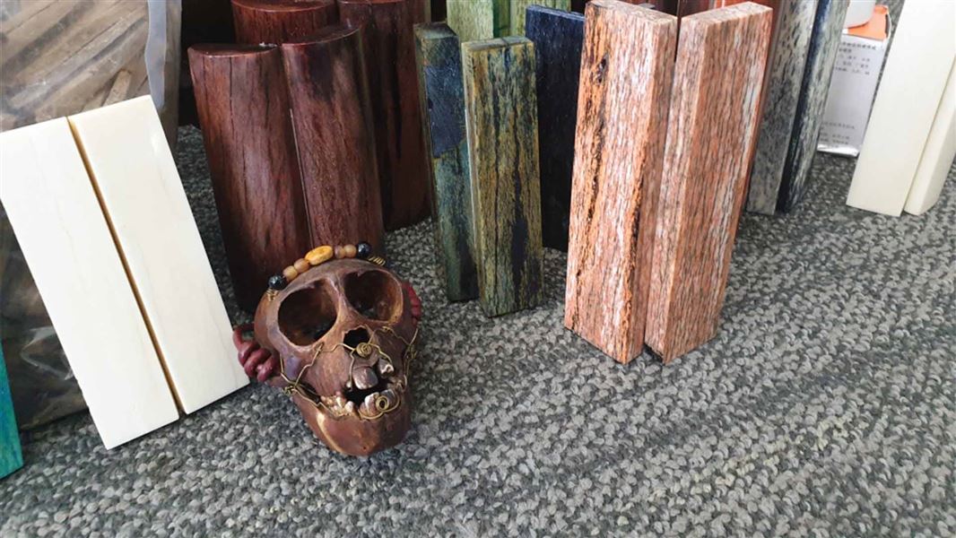 A decorated monkey skull next to blocks of giraffe bones.