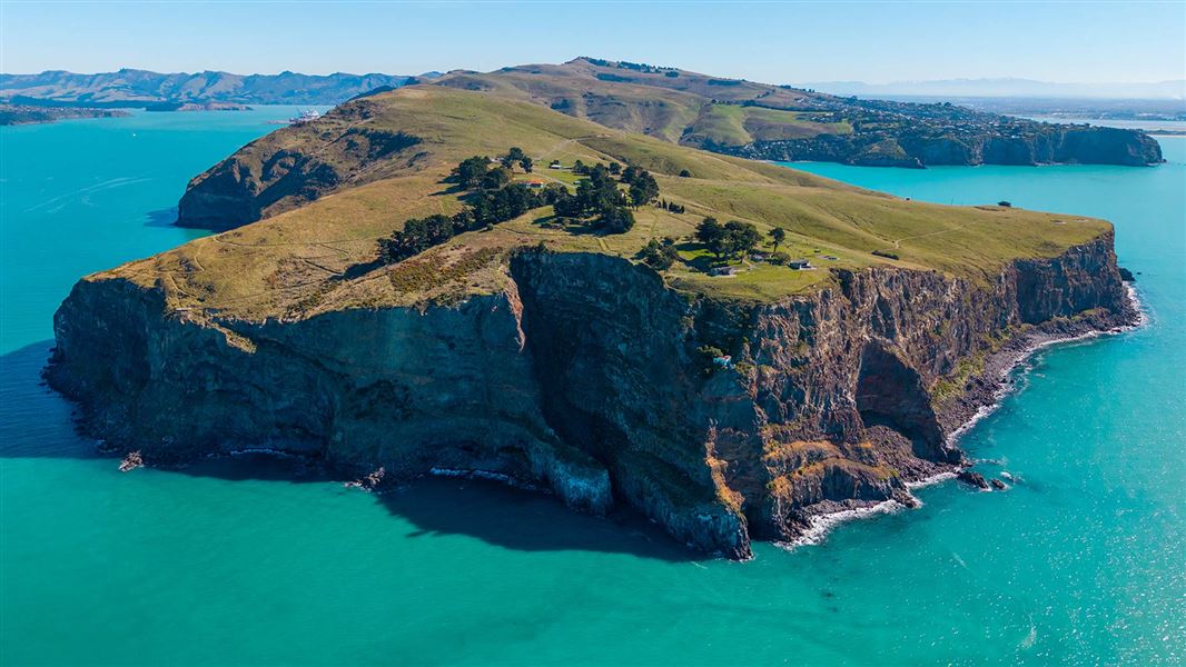 Bird's eye view over land bordering the sea. 