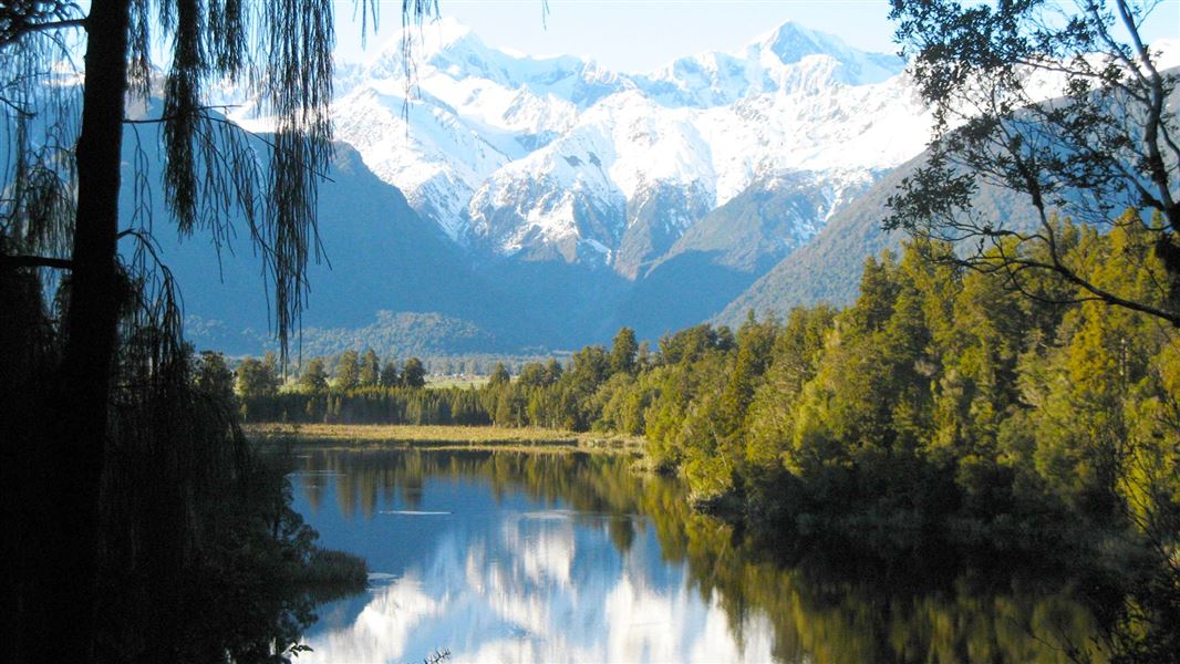 Snow capped mountains with reflection in the lake. 