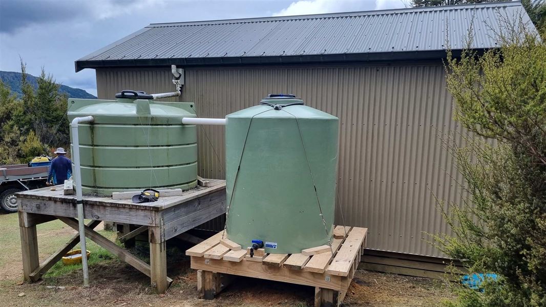 An old water tank and a new water tank installed at Red Hills Hut.