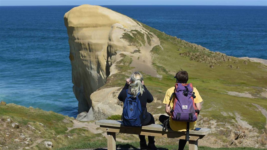 Visitors on Tunnel Beach track, Otago. 