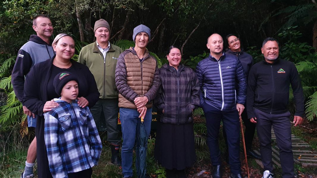 Various people of different ages stand for a photo.