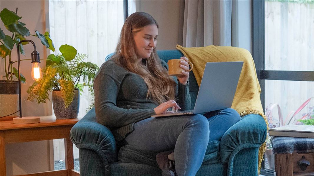 Female sitting with laptop on her knee, donating a trap online.