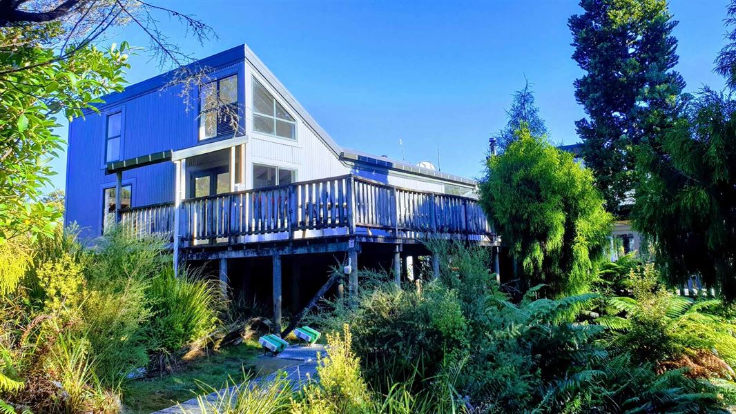 A building set amongst dense bush.