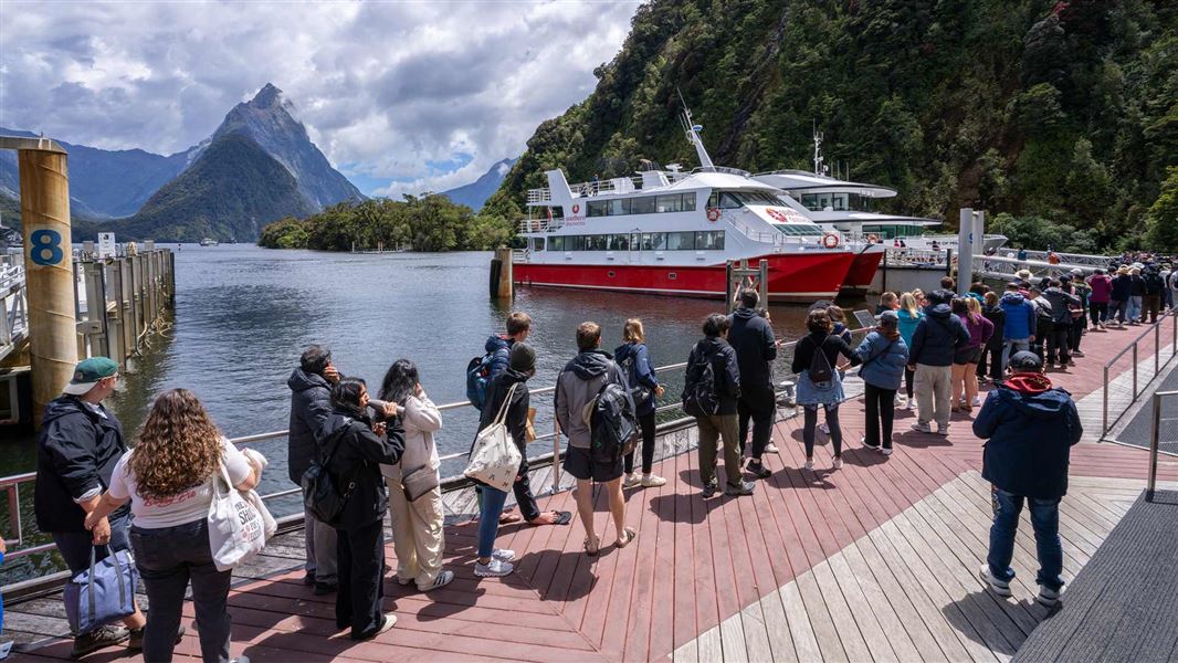 Long line of passengers waiting for Milford Sounds cruise. 