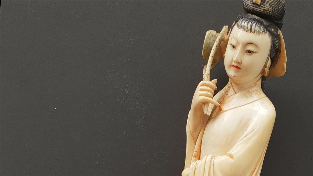 A statue of a woman carved from ivory