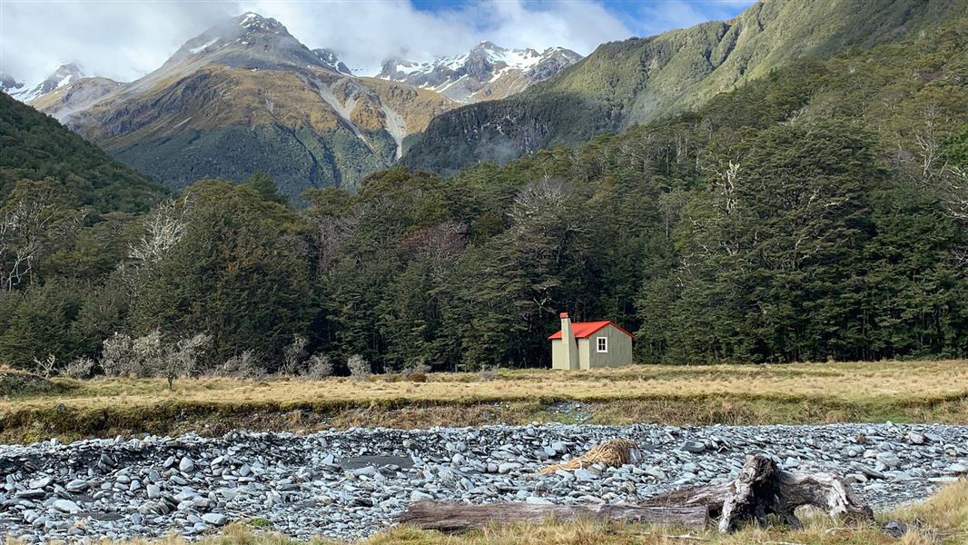 Small single story building near trees.