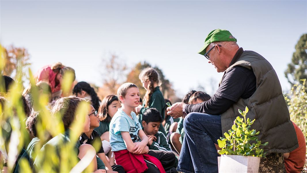 A teacher outside with a class of primary school students.