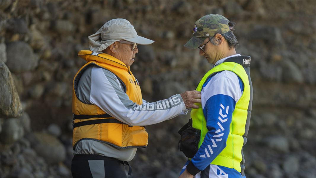 Two people wearing life jackets. 