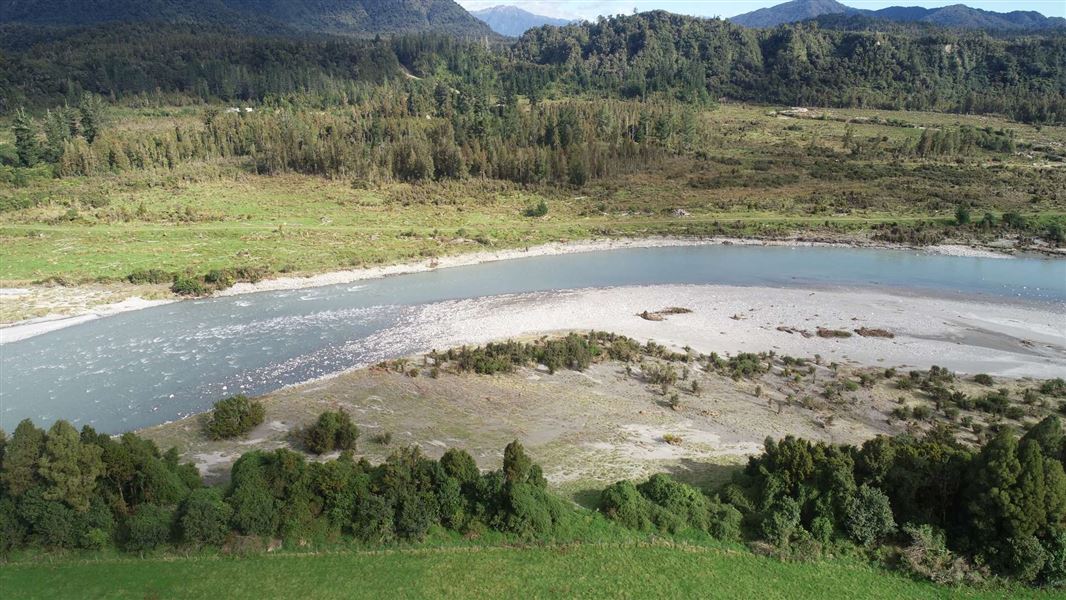 An aerial shot of a curved stretch of water.