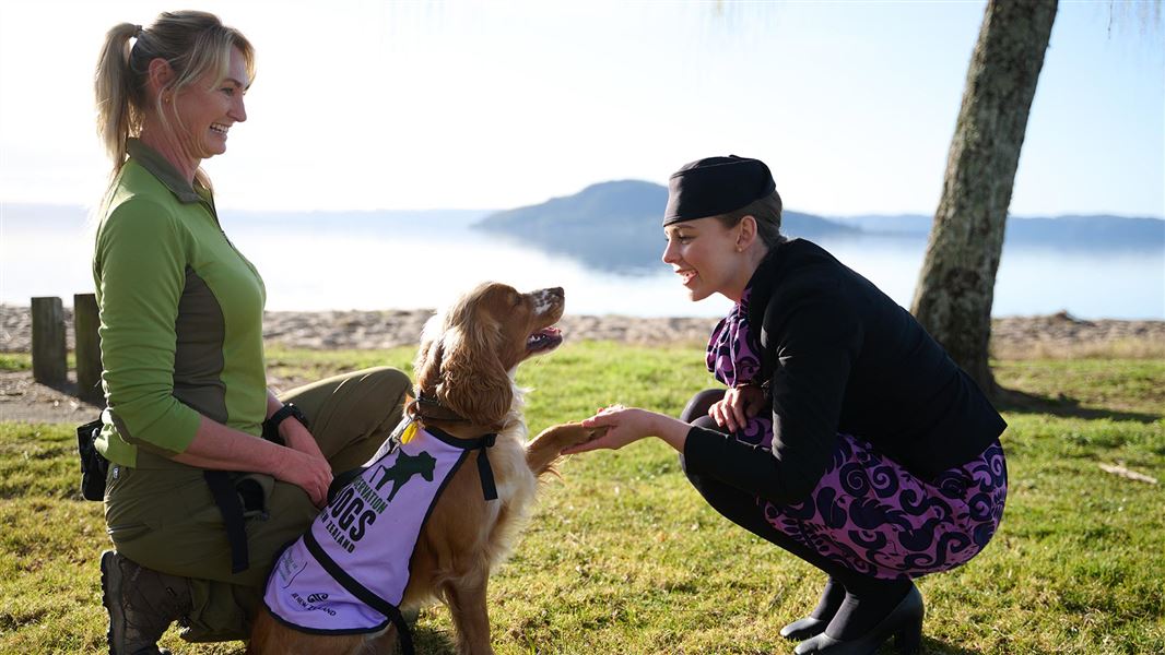 DOC Conservation dog handler Adeline with her dog, Blaze and Meghan, Air NZ flight attendant. 