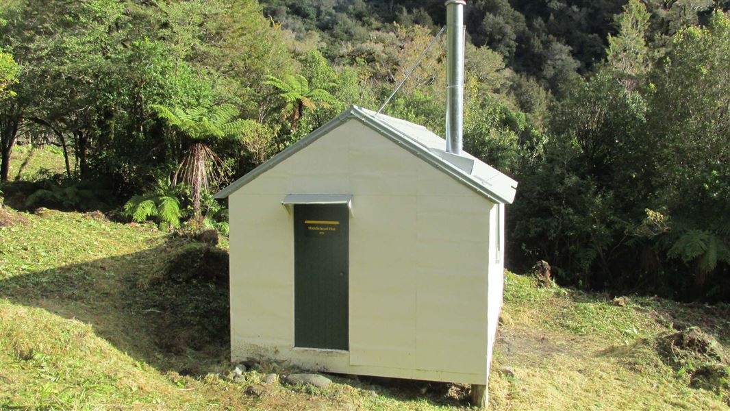 A small, painted white hut