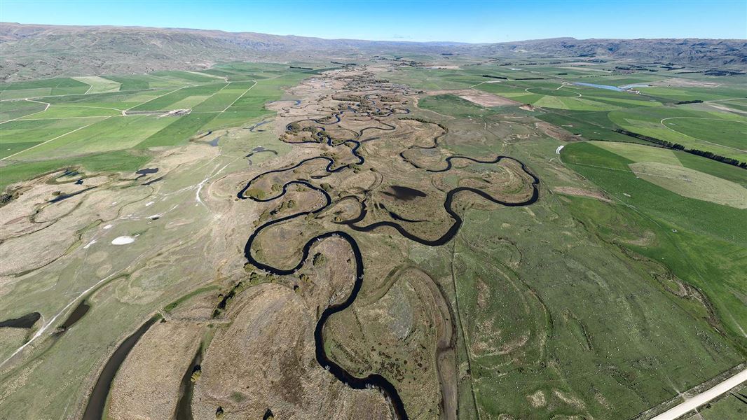 The Taiari river winds backwards and forwards in on itself, off into the distance.