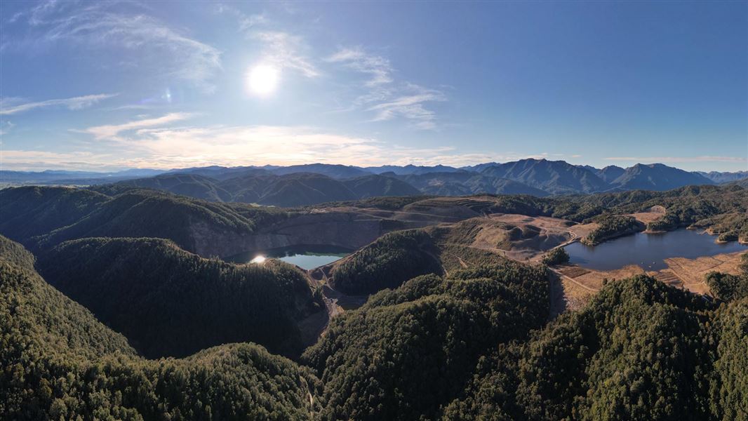 Panorama image of Globe Progress area showing lakes, trees and rolling hills. 