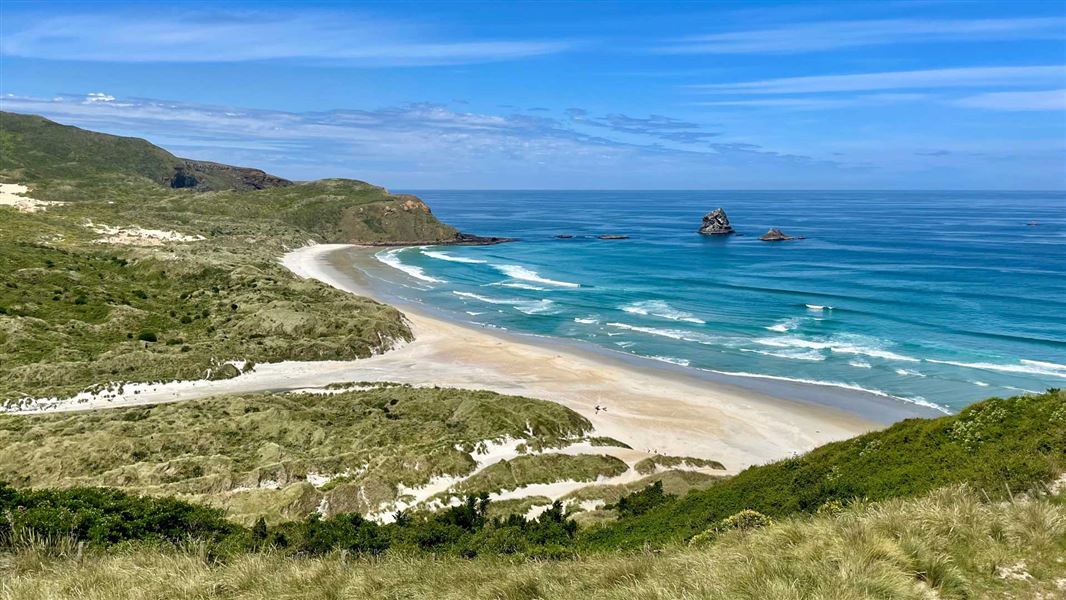 Landscape view over white sandy beach out to sea.