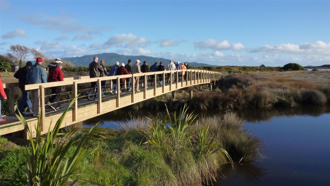 Visitors walking over bridge.