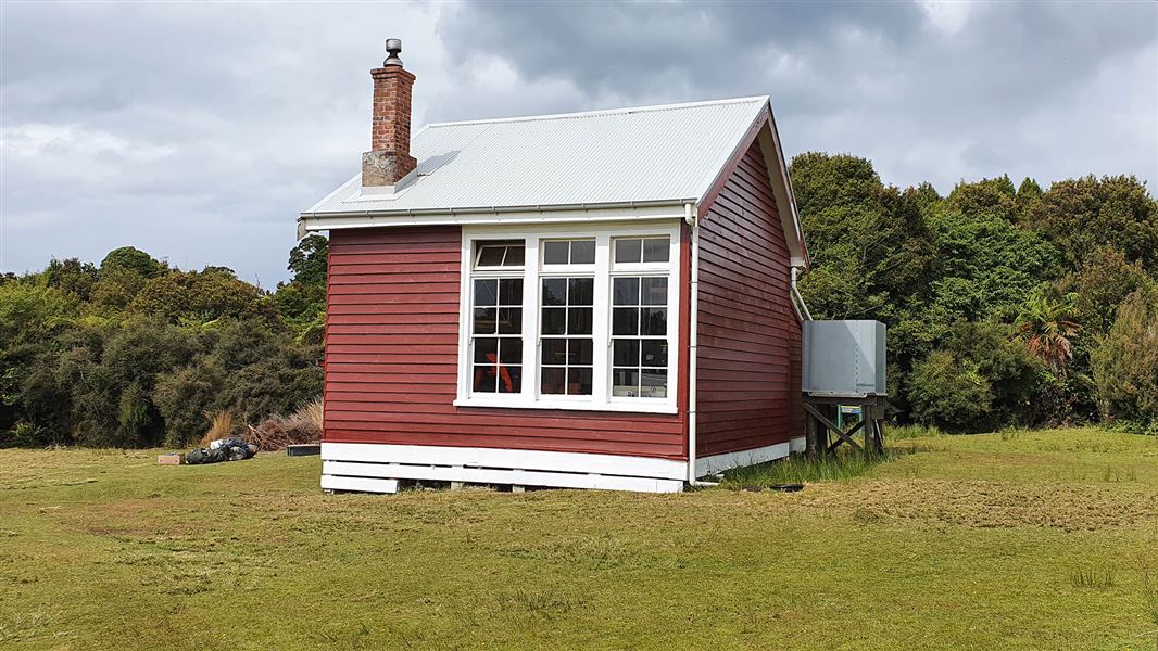 Small red building with brick chimney.