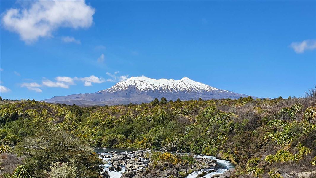 A multi peaked mountain jutting out of a barren area