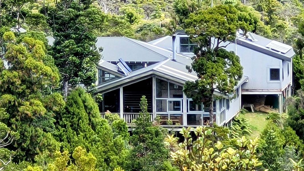 Lodge nestled among trees on a hillside.