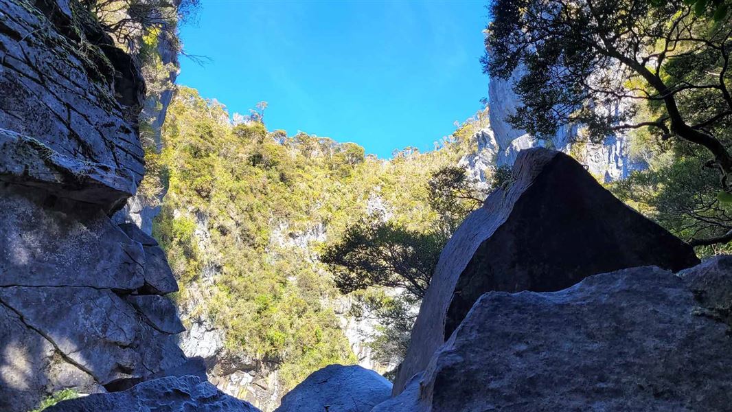 View through rocks to a large, natural amphitheatre.