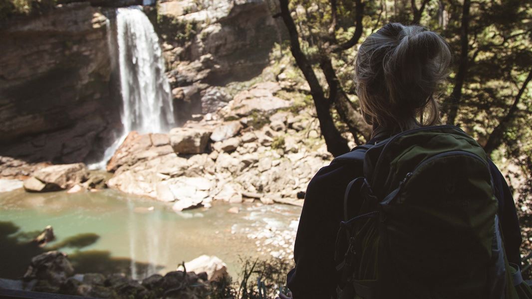 A person looks over a water fall.